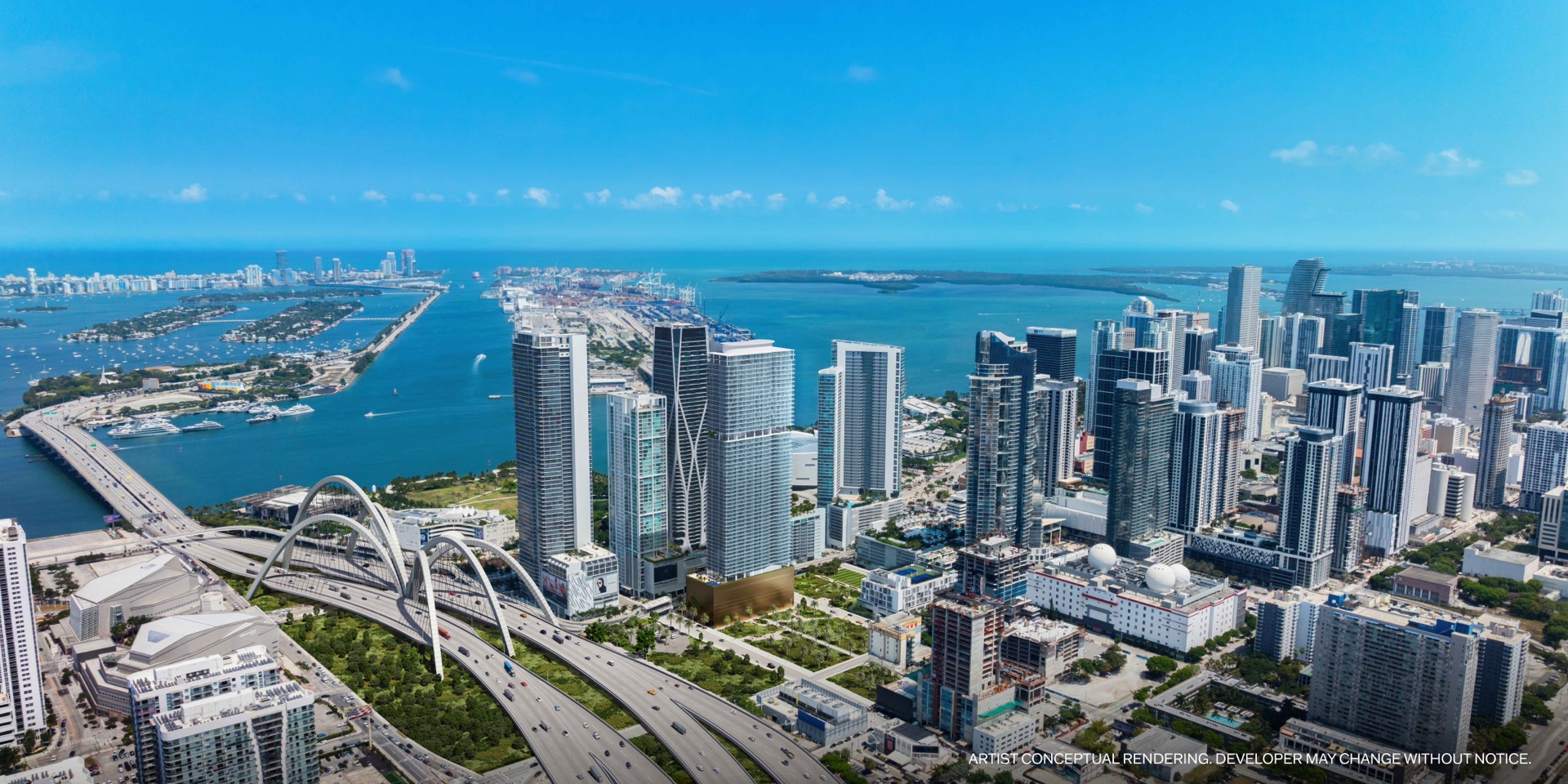 Aerial view of JEM Residences Miami — the Arquitectonica-designed tower rising at the center of Miami Worldcenter, one block from Biscayne Bay, with Downtown Miami and the bay beyond.